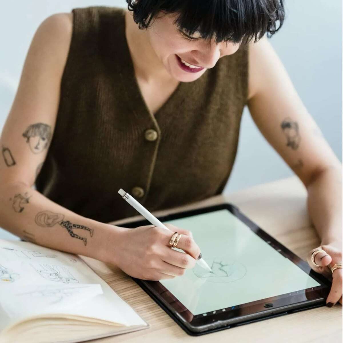 Person working on tablet with brown vest