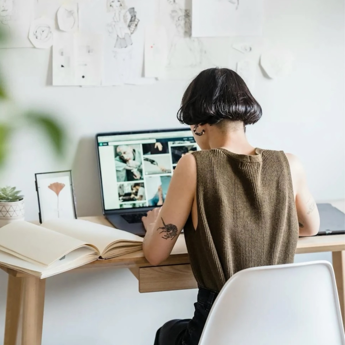 Person typing at computer with back facing the camera